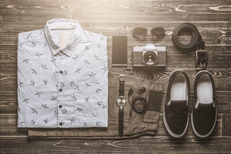 Flat lay photography of men's casual outfits, Outfits of traveler, boy, female, Men's casual outfits on rustic wood board background