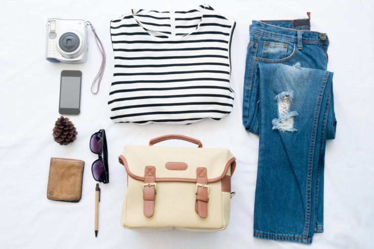 woman summer clothes collage on white,camera,bag,phone, flat lay, top view